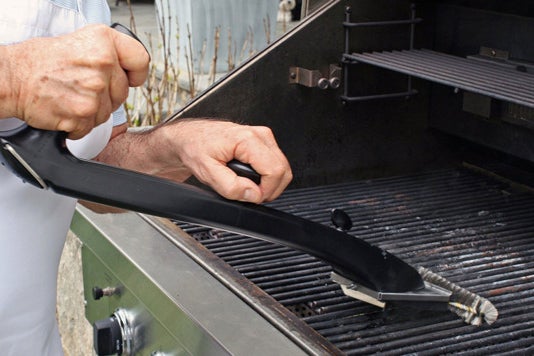 Grill Daddy Pro Bristle Lock Safety Grill Brush being used on a grill.